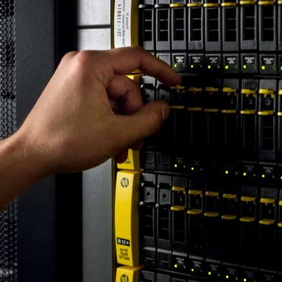 Industrial rack of hard drives being maintained